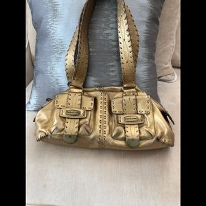 Micheal kors gold color purse.